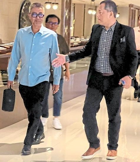 Calm before the storm: Datuk Yusoff Mahadi (left) walking alongside FAM honorary president Tan Sri Hamidin Mohd Amin.