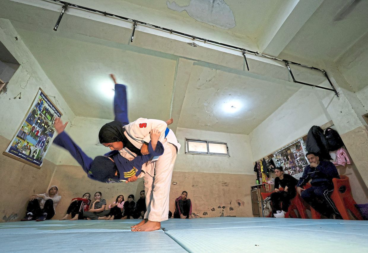 Young girls in action during a judo training session.