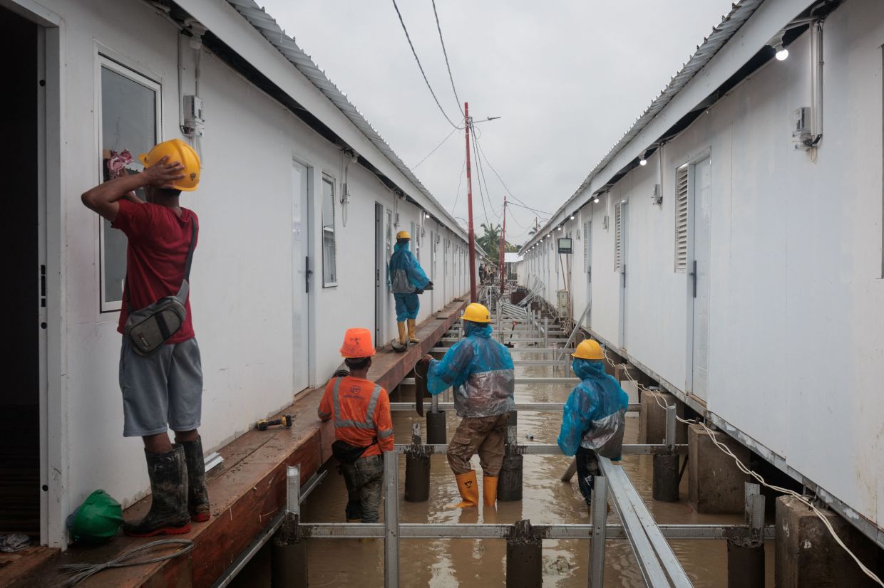 Temporary housing units built by Danantara, an Indonesian state-owned investment agency, are being constructed for residents evacuated by flash floods, as construction continues at 14 locations in Aceh Tamiang, Aceh province-- Photo by ADITYA AJI / AFP