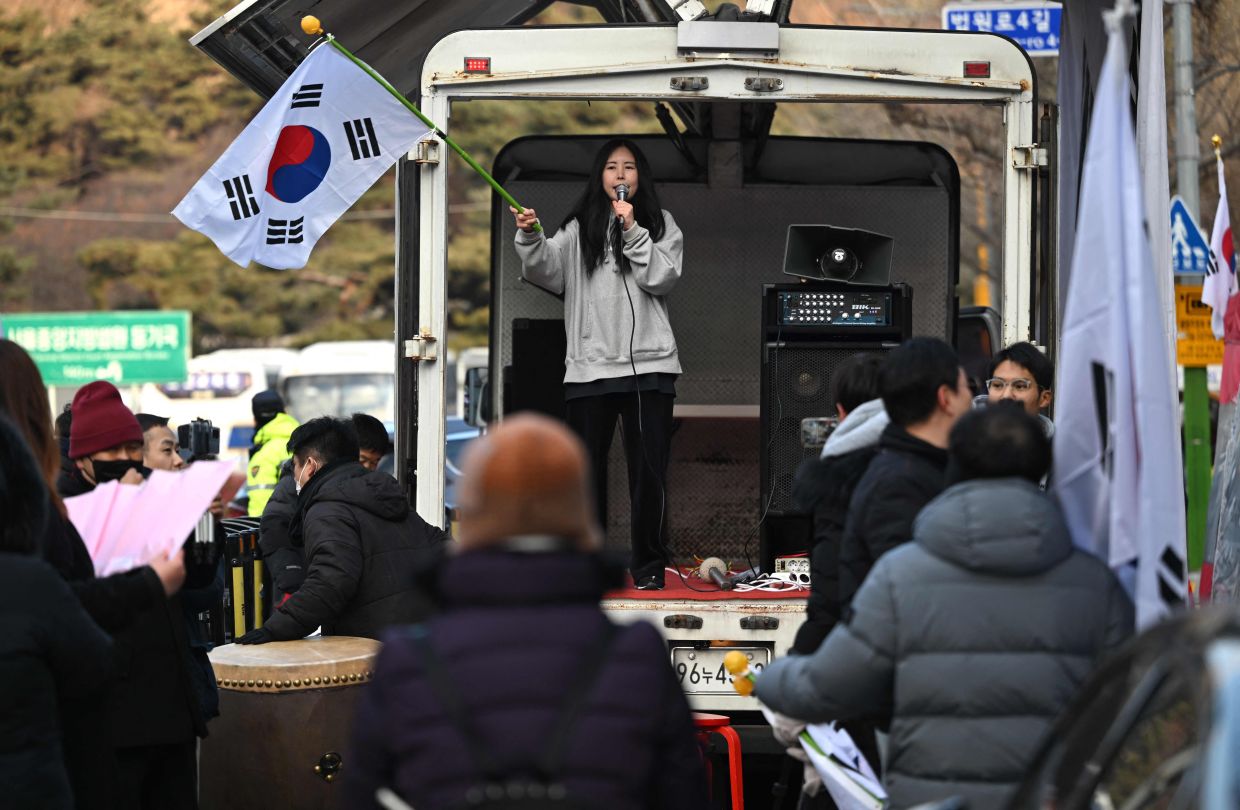 Supporters of South Korea's former impeached president Yoon Suk Yeol gather in front of the Seoul Central District Court in Seoul on Friday, January 9, 2026, as Yoon's final criminal trial on insurrection charges is held in the court. -- Photo by Jung Yeon-je / AFP