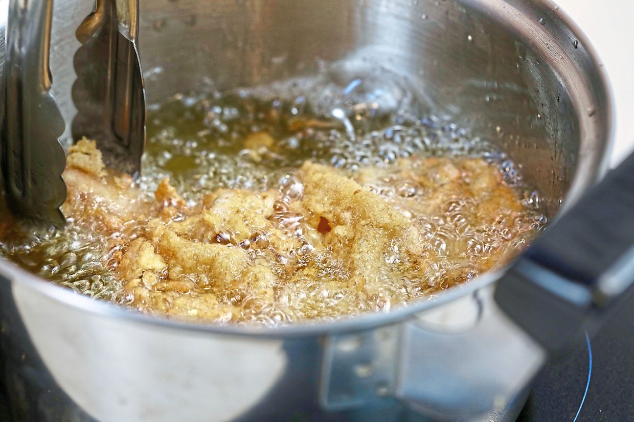 Fry the coated chicken pieces over medium low heat until golden and crispy. Dredge the marinated chicken in flour, then egg and finally coat with breadcrumbs before frying.