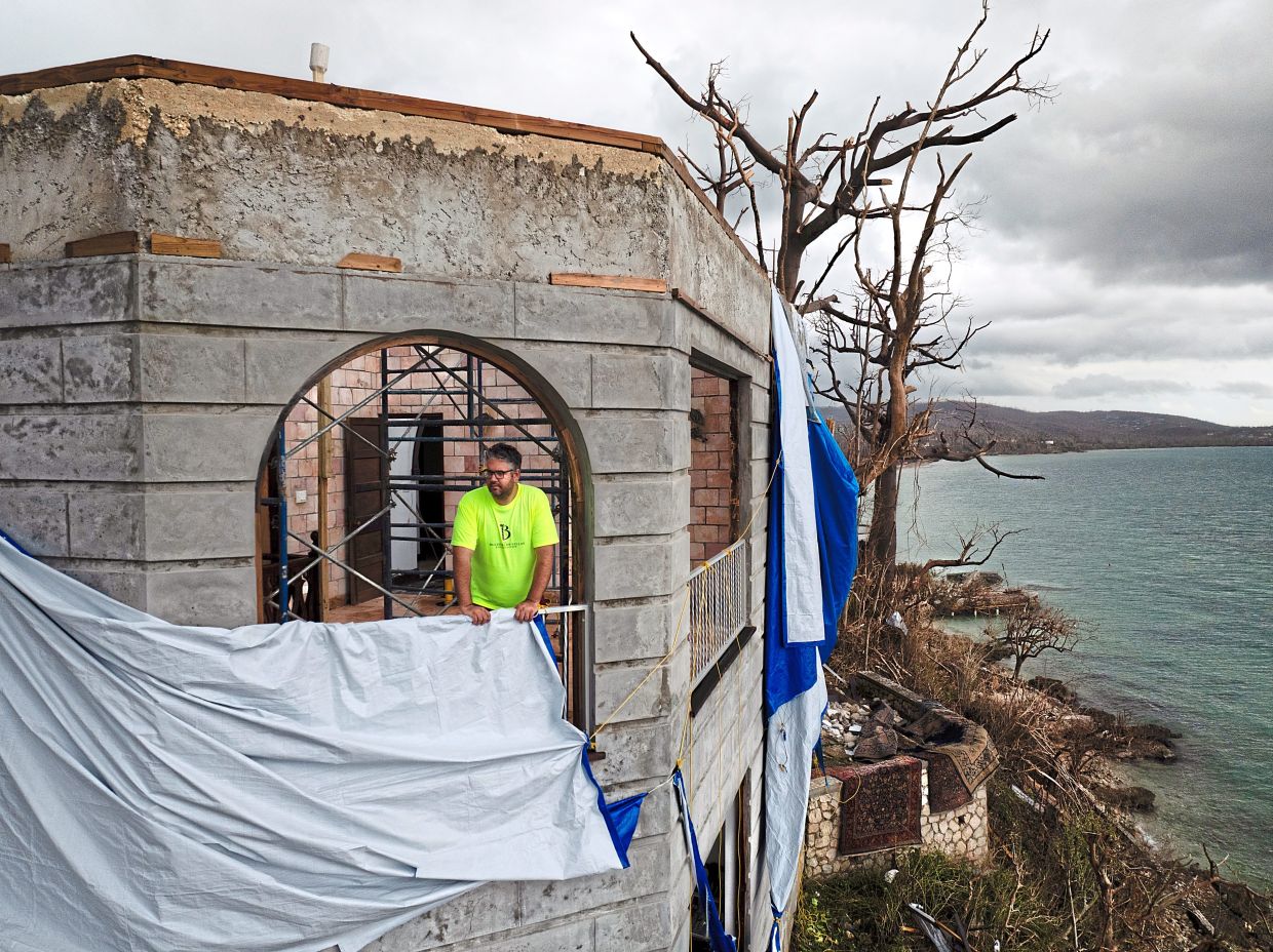 Houston Moncure looking out from an upper floor of the severely damaged Bluefields Bay Villas, a resort he owns with his family, in Westmoreland, Jamaica.