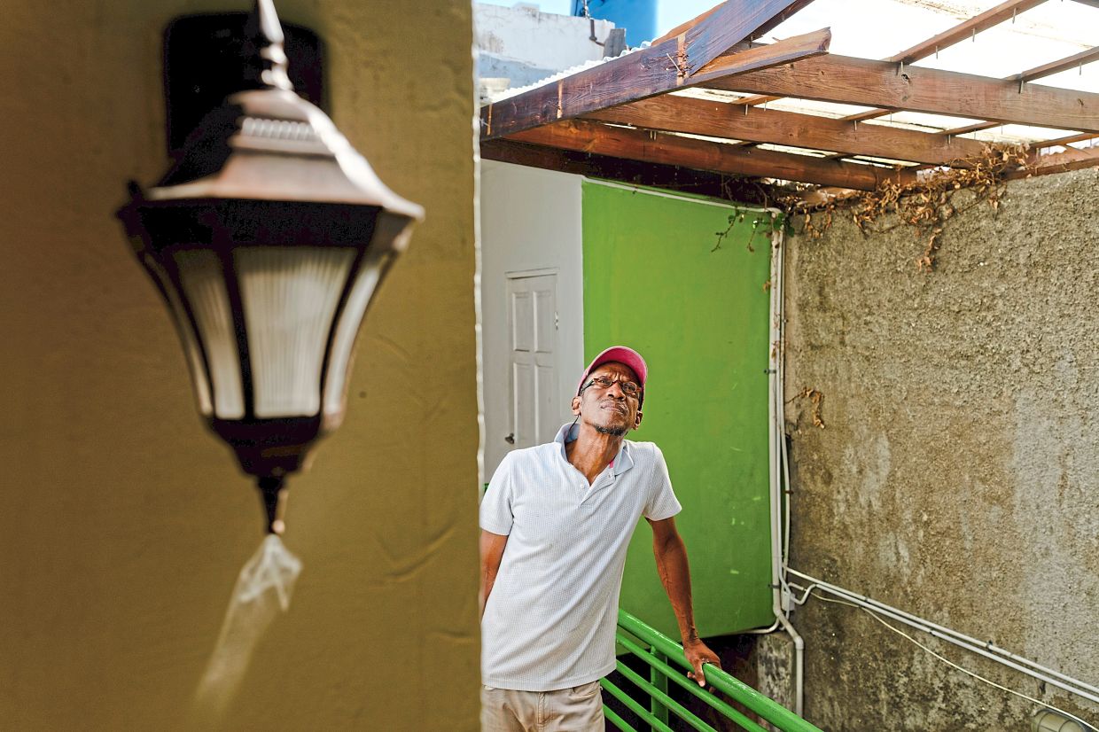 Jarrett inspecting a section of missing roof at his Altamont West Hotel in Montego Bay. — Erin Schaff/The New York Times