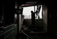 Kyiv residents grapple with cold after Russian strike rips open apartments