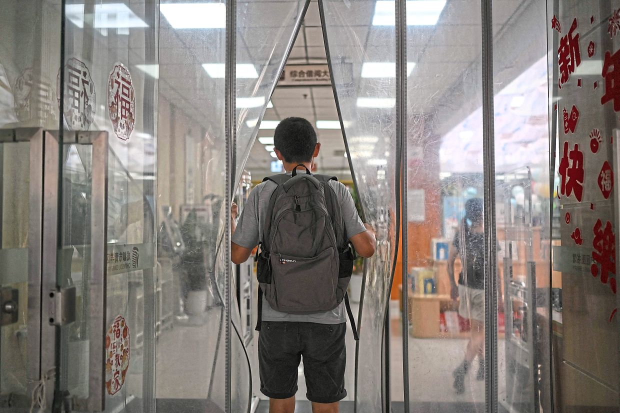 Gateway to change: Hu entering a public library in Chengdu. — AFP
