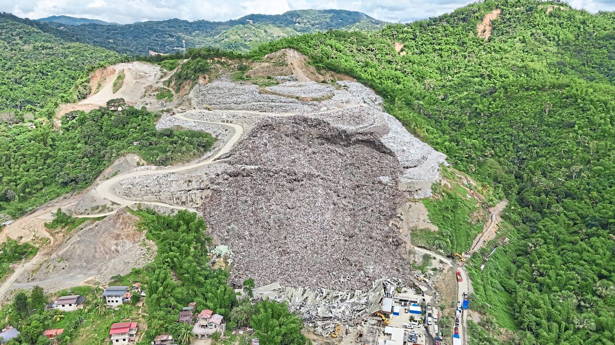 Public concern: A huge mound of garbage that collapsed at the waste segregation facility in Binaliw. — AP
