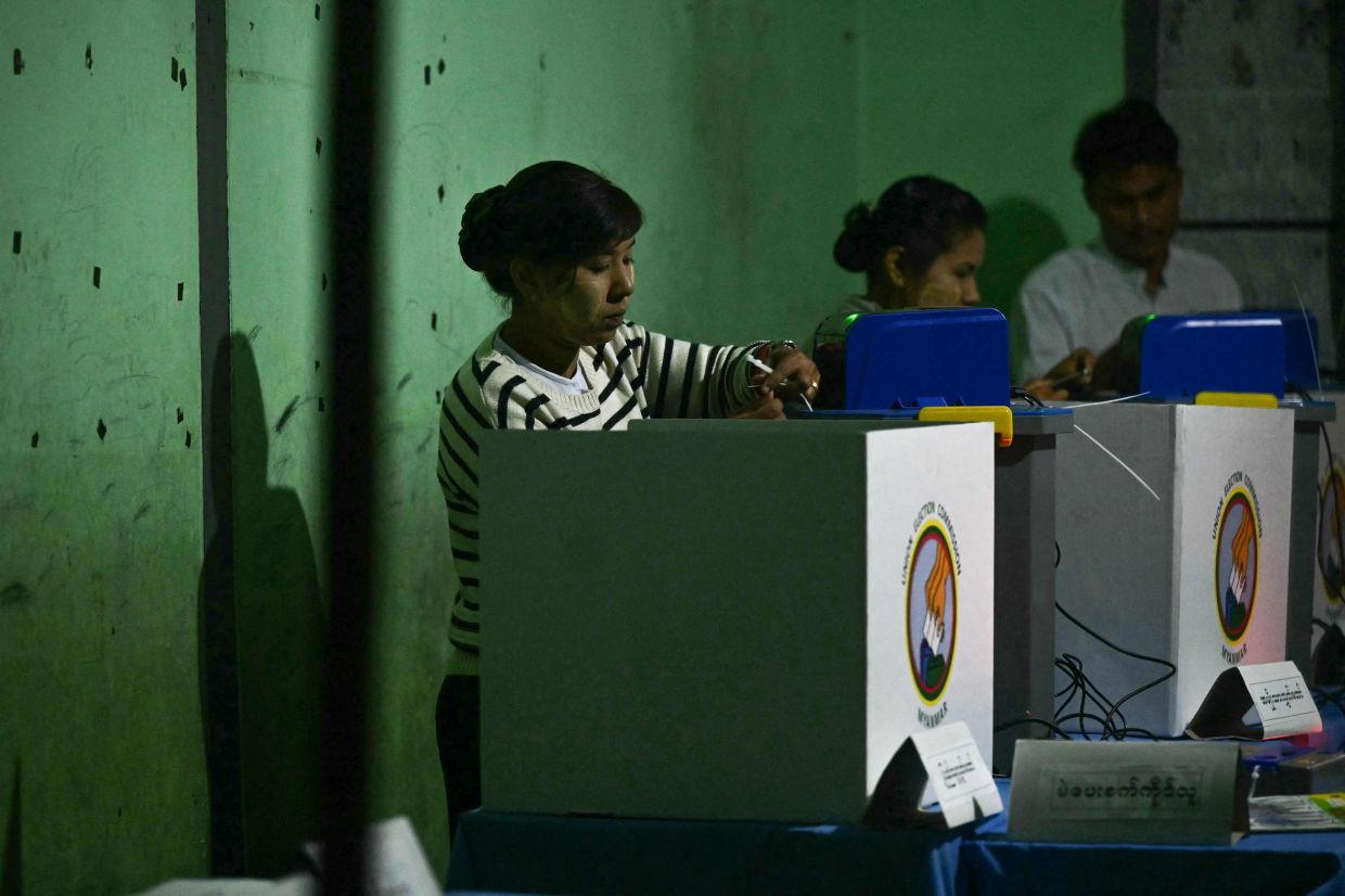 Election volunteers make final preparations before the opening of a polls for the second phase of Myanmar's general election, at a polling station at Kawhmu township in Yangon on January 11, 2026. Myanmar's junta opened polls on January 11 in the second phase of elections, continuing a vote democracy watchdogs say is letting the military prolong its rule in a civilian guise. - Photo: AFP