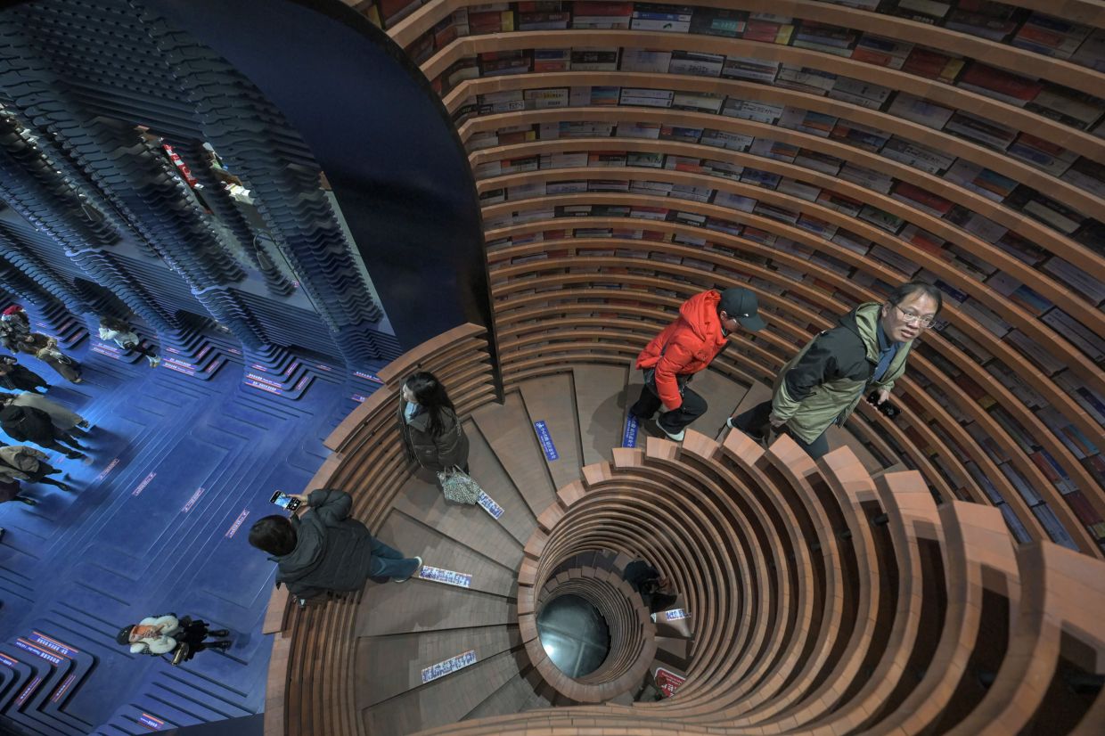 Towering accordion steps and a fantastical spiral staircase greet visitors to a massive bookstore in northern China's Tianjin. Photo: AFP 