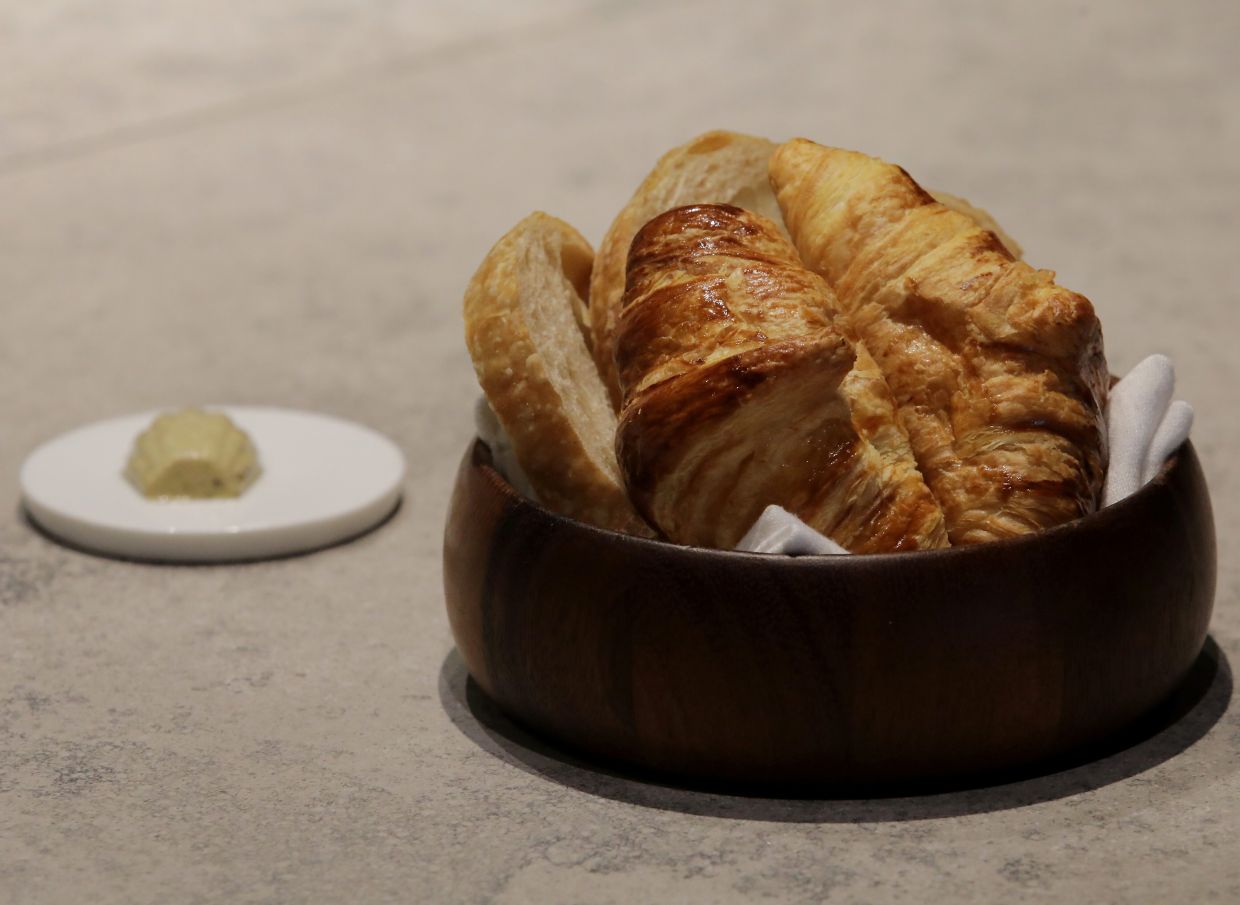  Artisanal Bread Basket (RM18) which features a canvas of homemade croissants and sourdough bread.