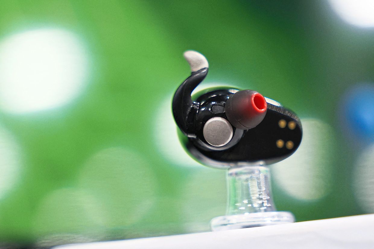 Naqi Logix showcased a pair of neural earbuds that enable hands-free control of digital devices using subtle facial movements. — AFP