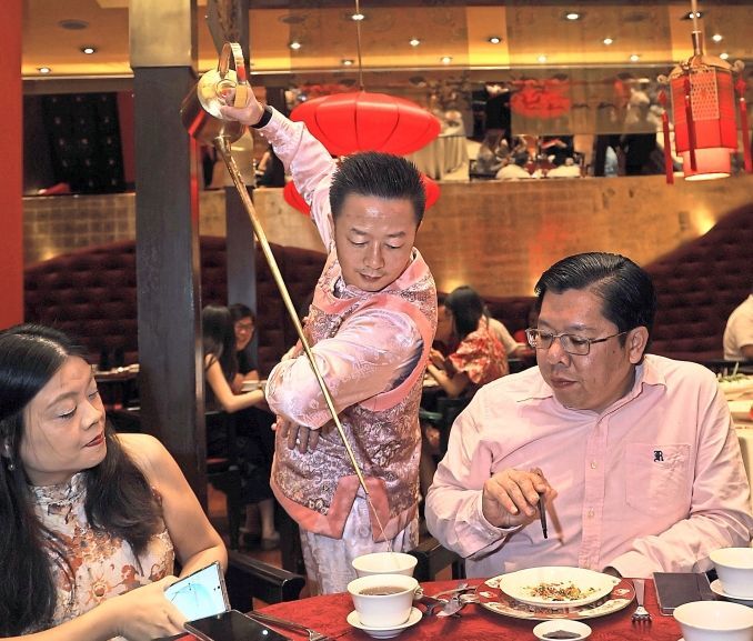 A tea master showing off his pouring skills.