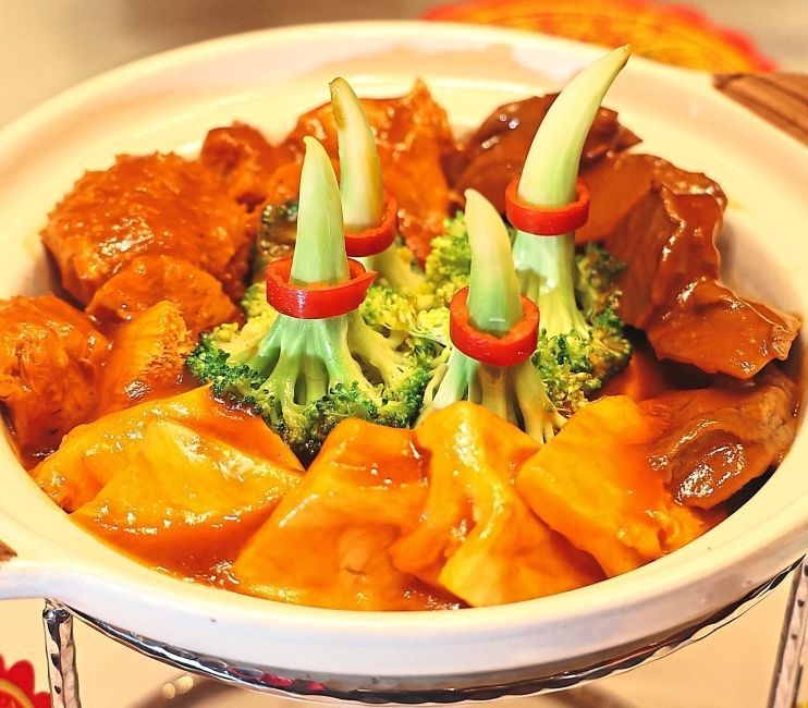 Braised wild abalone cubes, fish maw, monkey head mushroom and garden greens.