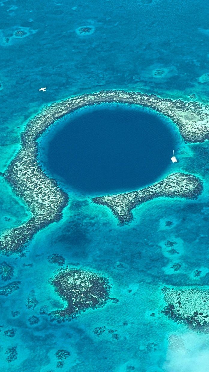 The Great Blue Hole in Belize is a massive ... hole that’s roughly 300m in diameter and over 120m deep, said to be formed during the Ice Age. The travel group with tour guide Roberto (right) at Xunantunich, one of the best-preserved examples of an ancient Maya civilisation. 