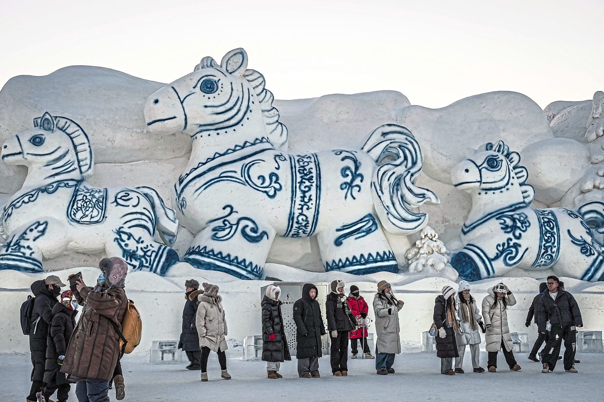 A gorgeous snow sculpture of horses at the festival. — Jade GAO/AFP