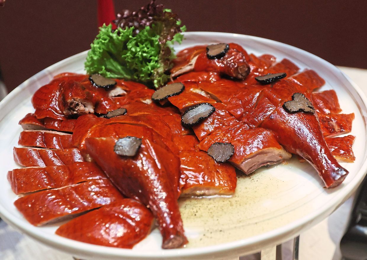 Roast duck is air-dried for 48 hours before roasting, for maximum crispiness. The duck is served with aromatic truffle slices.