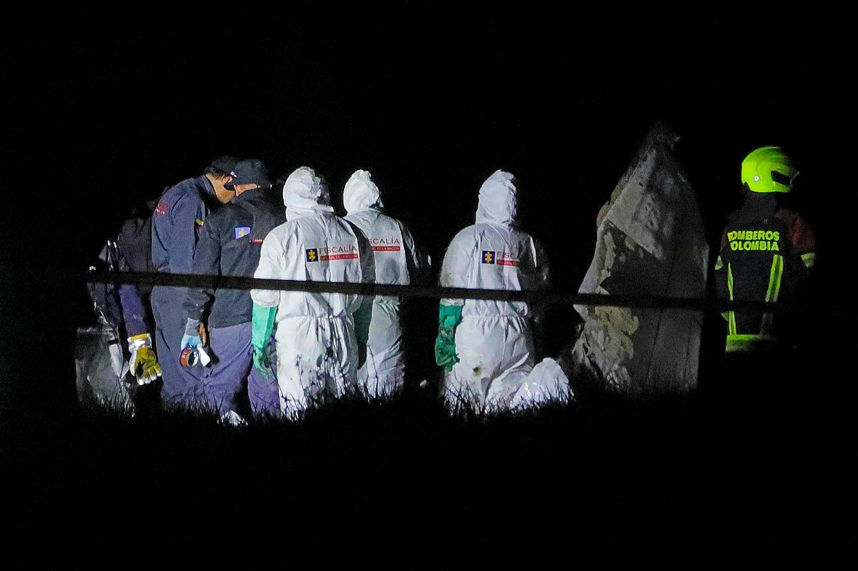 Members of the Attorney General's Office and firefighters work on the recovering of bodies after a plane crashed, leaving six people dead, including Colombian popular singer Yeison Jimenez, at Romita rural area in Paipa municipality, Boyaca department, Colombia on January 10, 2026. Photo: AFP