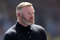 Soccer-Rooney open to Man United return if Carrick named interim manager