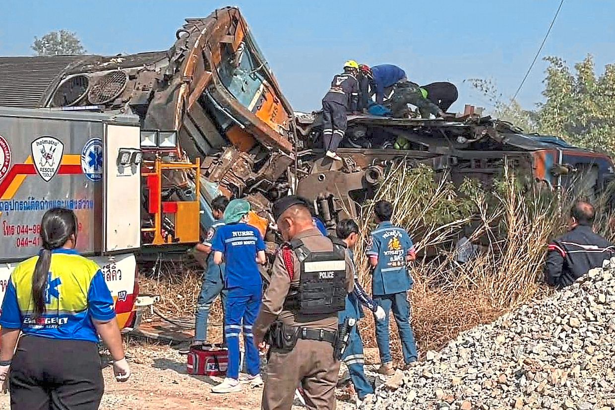 Ground zero: Aid workers at the crash site. — AP 