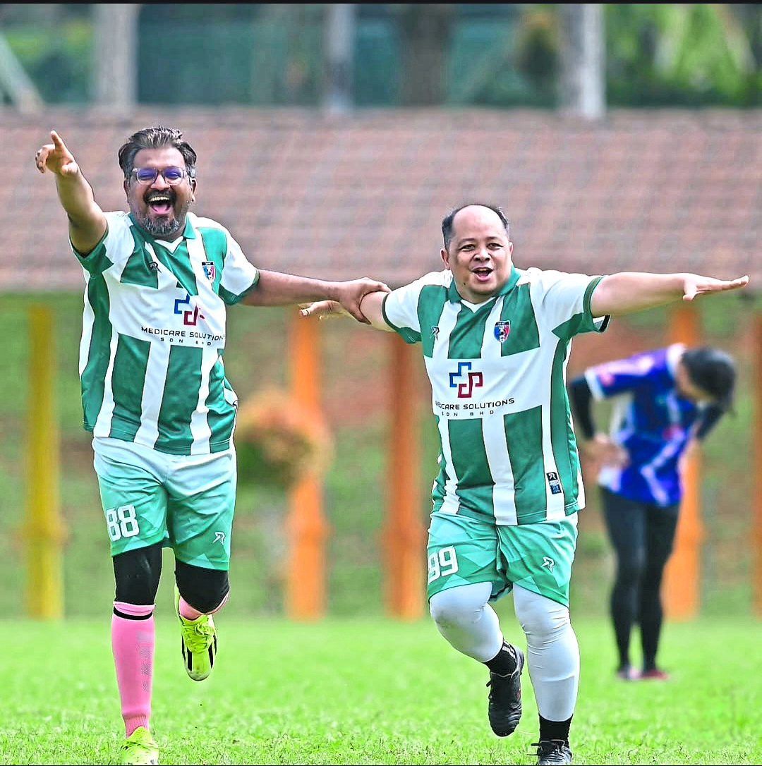 Even a neurosurgeon needs a kick – Dr Moventhiran (left) relaxes by playing football in his free time. Photo: Instagram/Abanghijauofficial