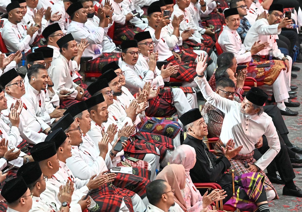 Warm welcome: Khairy waving to the crowd at the assembly in Dewan Merdeka.