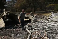 Australia warns of floods, fires after cars washed away