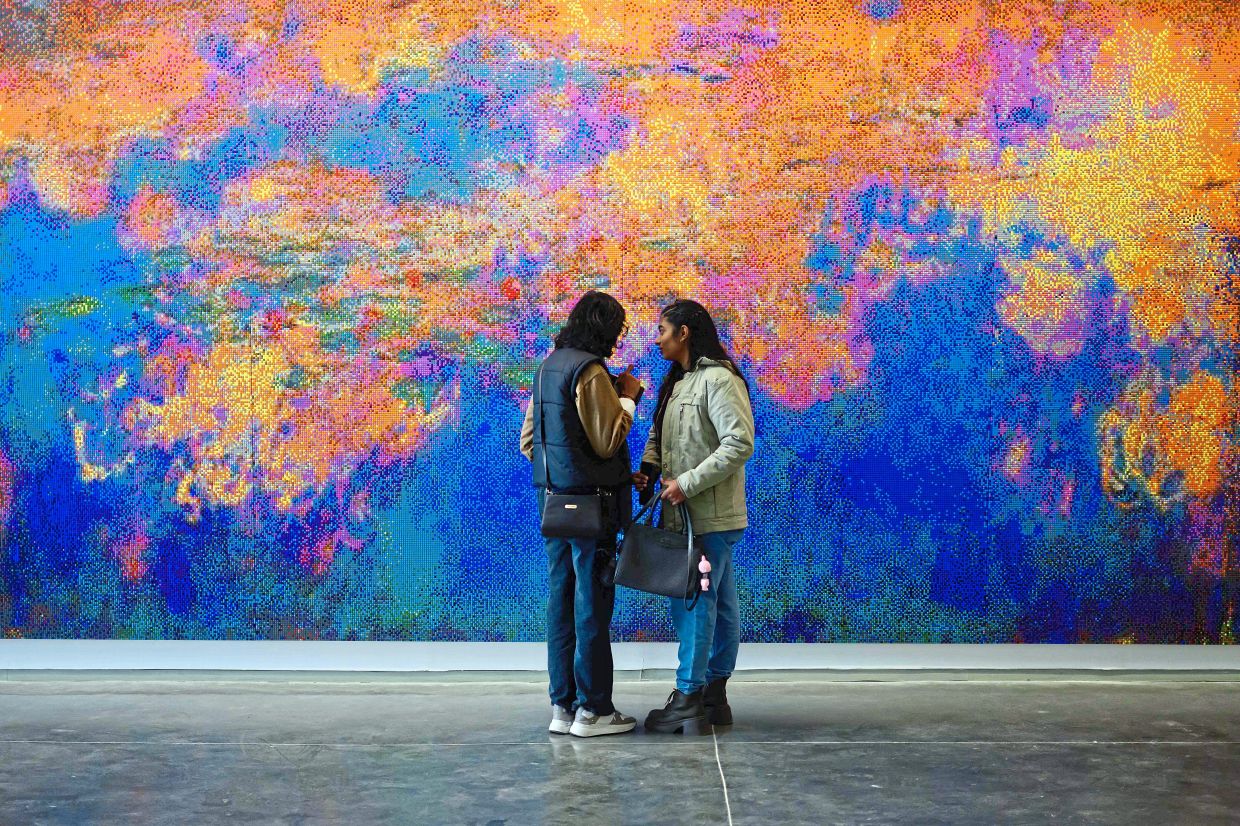 Visitors look at an artwork titled 'Water Lilies by Chinese artist Ai Weiwei at the Nature Morte gallery in New Delhi. Photo: AF{ 