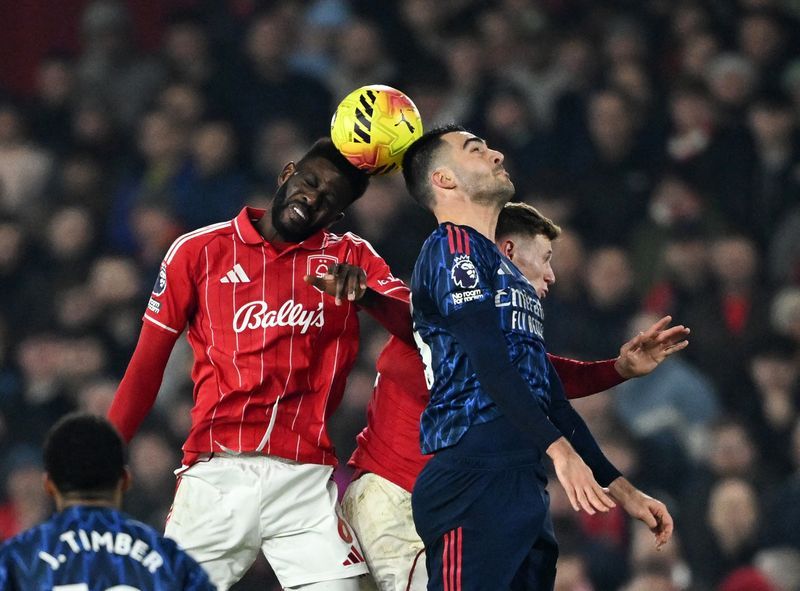 Soccer-Arsenal held by Forest but move seven points clear at top