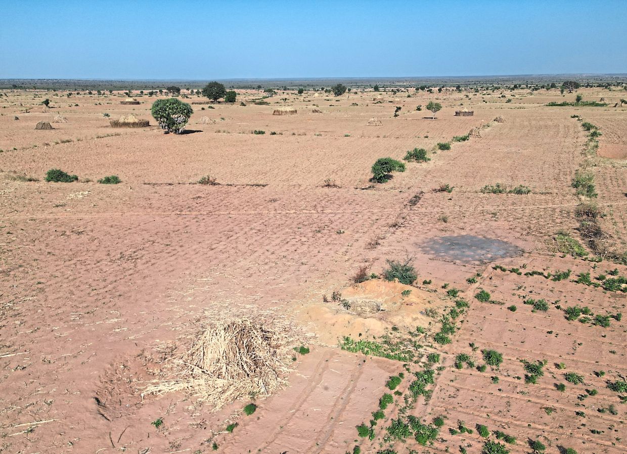 Debris from a missile landed near a round well and burned corn stalks gathered for cattle feed in Jabo. — Taibat Ajiboye/The New York Times