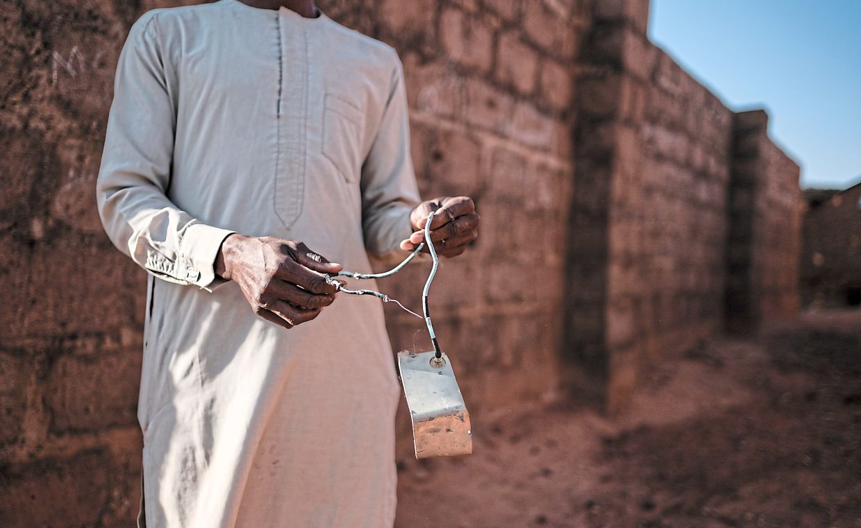 A resident with debris he said he found after a missile attack in Jabo. The small town is grappling with the aftermath of a bombing ordered by Trump. — Taibat Ajiboye/The New York Times