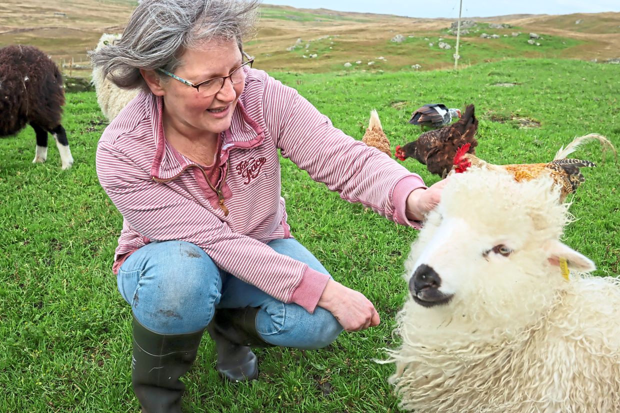 Pritchard with one of her sheep on her farm in Walls.
