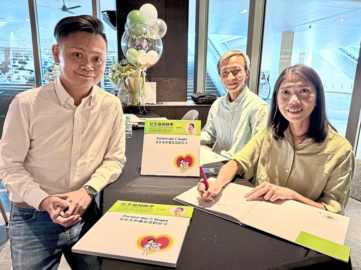 Tio (right) with Prof Ho (centre) and Yong at her picture book launch and signing.