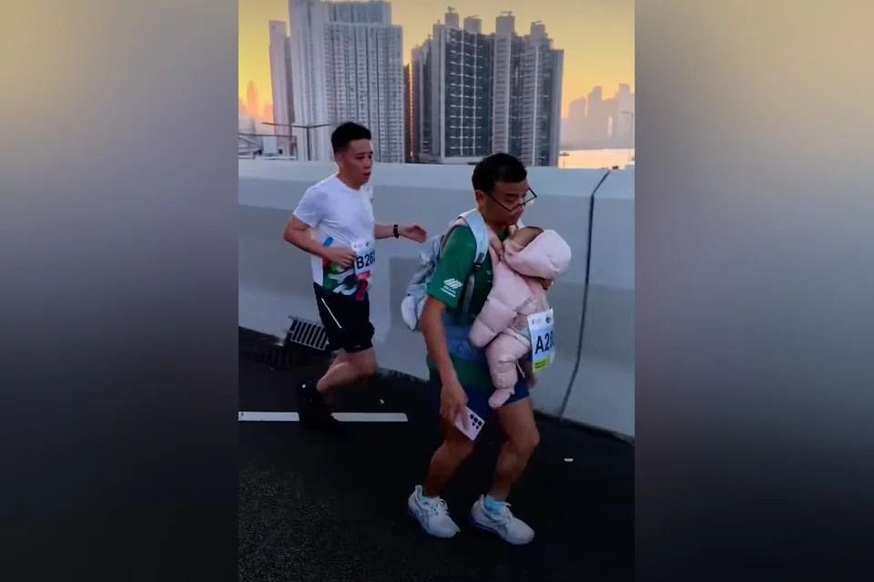 Man running HK marathon while carrying baby gets booted, banned from race and roasted online