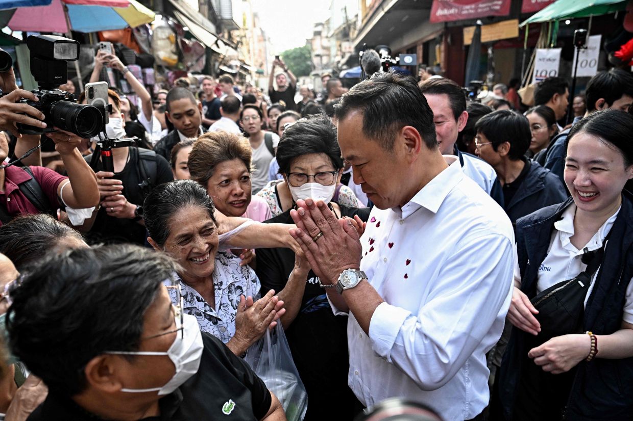 Thailand's prime minister and Bhumjaithai Party leader Anutin Charnvirakul (second right) greets people at a market while campaigning ahead of the general election, at Chinatown in Bangkok on Tuesday, January 20, 2026. -- Photo by Lillian SUWANRUMPHA / AFP