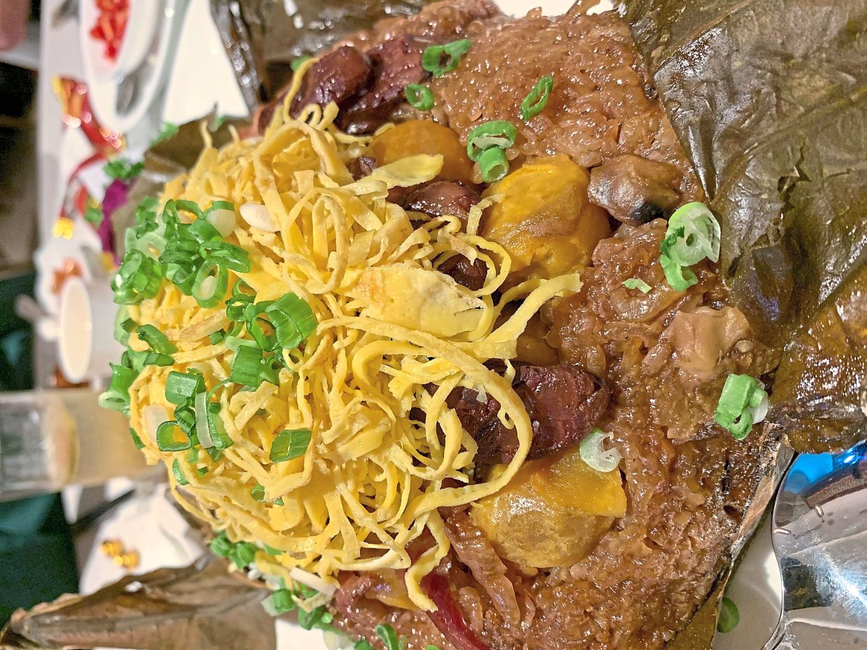 Fried Glutinous Rice with Cantonese Cured Meat wrapped in Lotus Leaf.