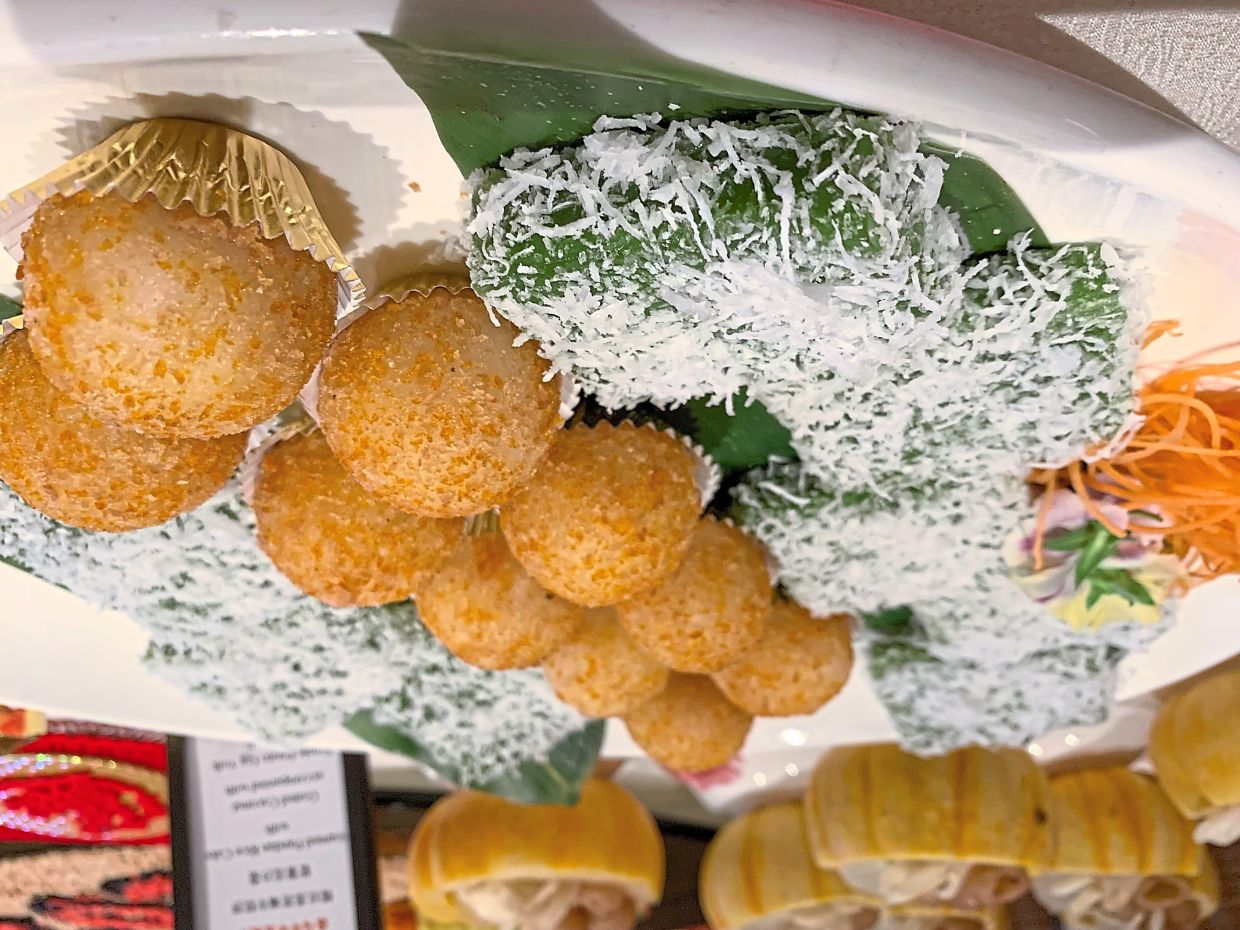 Steamed Pandan Rice Cake with Grated Coconut and Purple Potato Egg Yolk Lava Ball.