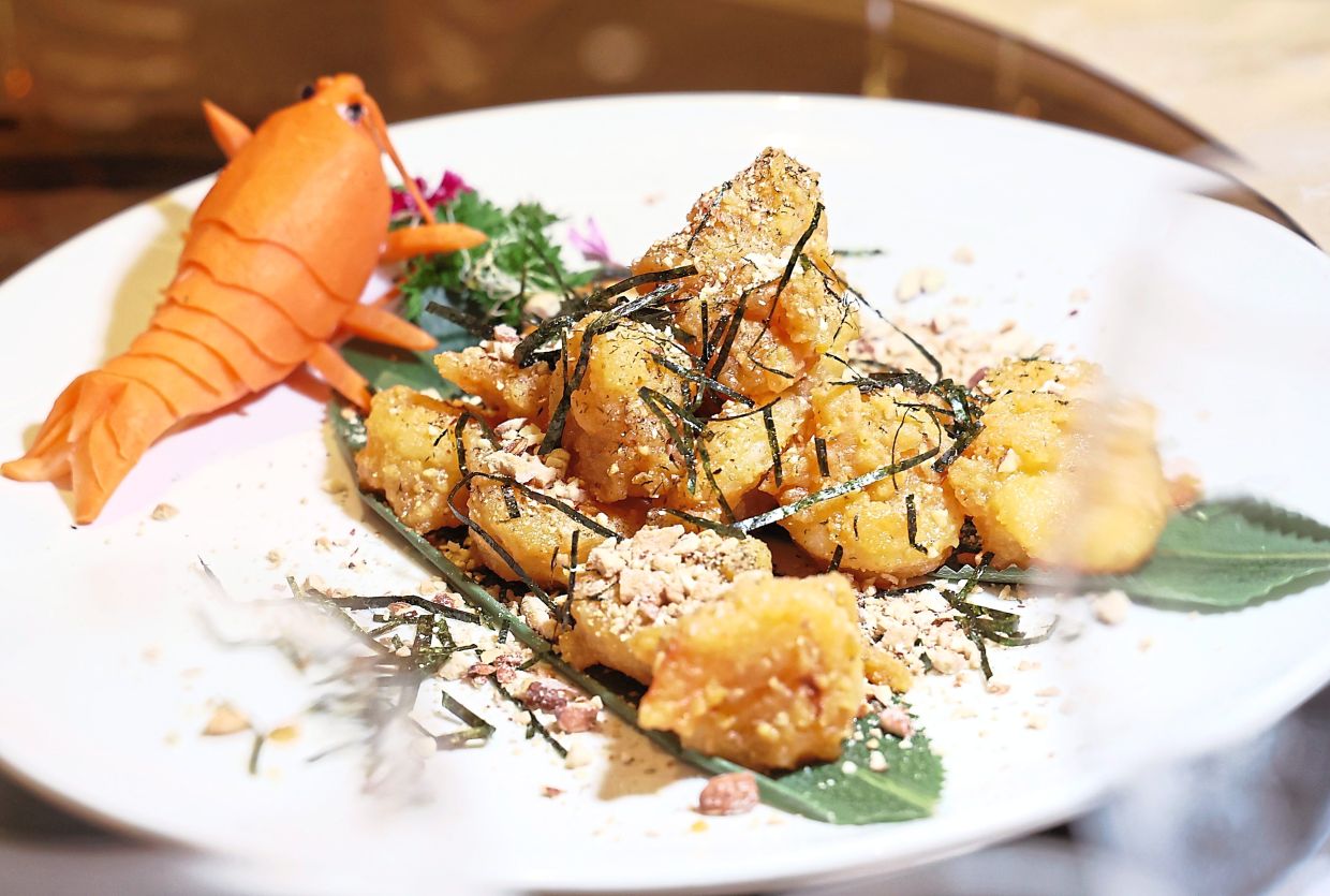 Stir-fried Prawns with Salted Egg Yolk crafted to resemble little gold ingots.