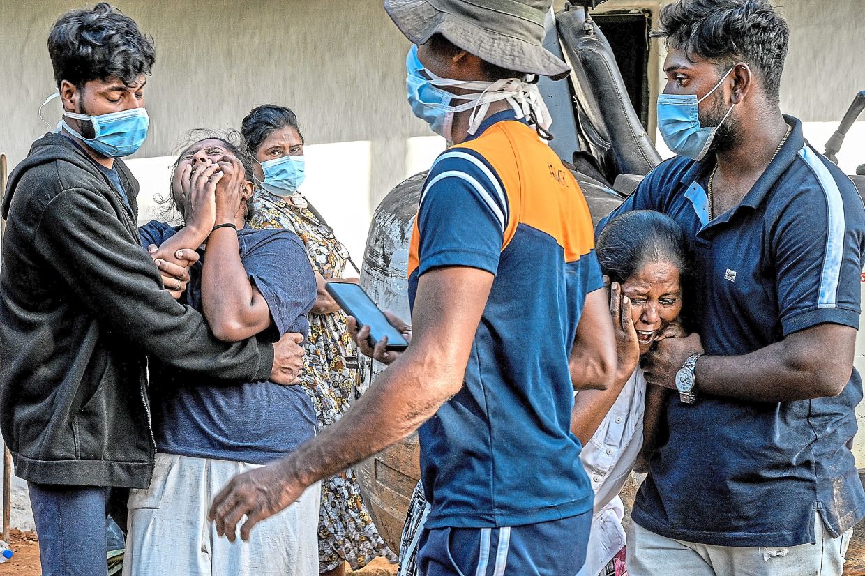 Vasantha (second from right) and Saranya (second from left) reacting after identifying a body. — Atul Loke/The New York Times