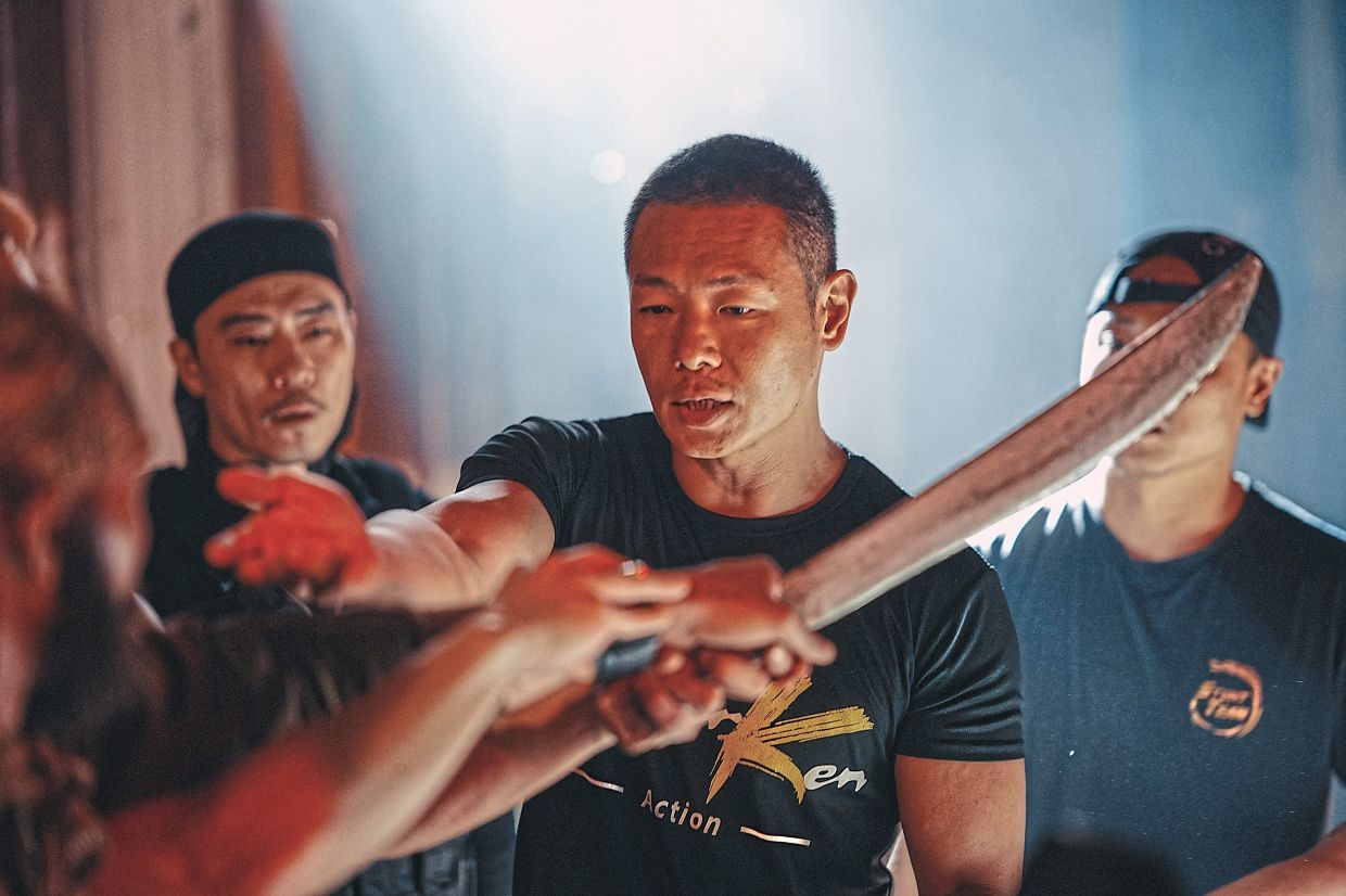 Hong Kong stunt master Ken Law (centre) guides the cast on how he wants them to execute an action scene. Photo: Handout