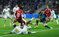 Soccer-Clinical Liverpool edge closer to last 16 with Marseille win