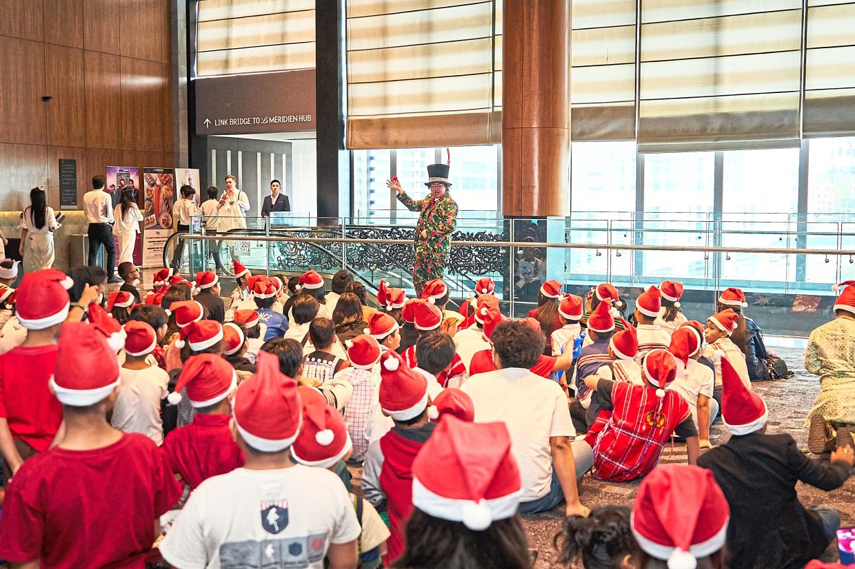 Frankie the Magician dazzling the children with his tricks and charm.