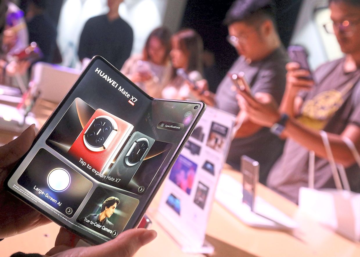Visitors trying out the Huawei Mate X7 smartphone which unfolds to deliver high performance. It is also durable and features extras like high definition video recording. The smartphone was launched alongside Huawei FreeClip 2 earbuds and watches in Kuala Lumpur.