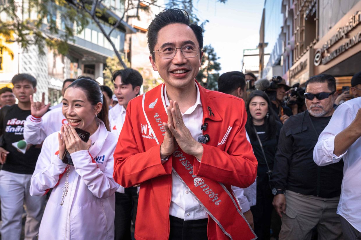 Pheu Thai Party prime ministerial candidate Yodchanan Wongsawat (centre) walks with fellow party members while campaigning ahead of the general election, at Siam Square in Bangkok on Friday, January 23, 2026. -- Photo by Chanakarn Laosarakham / AFP