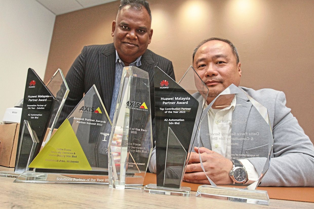 Aru and Ang with some of the excellence awards won by the company.
