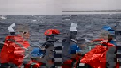 China says two people are dead and four still missing after Philippine boat capsizes near disputed shoal; 15 sailors rescued