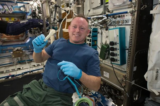  International Space Station Expedition 42 Commander Barry 'Butch' Wilmore shows off a ratchet wrench made with a 3-D printer on the station. - NASA
