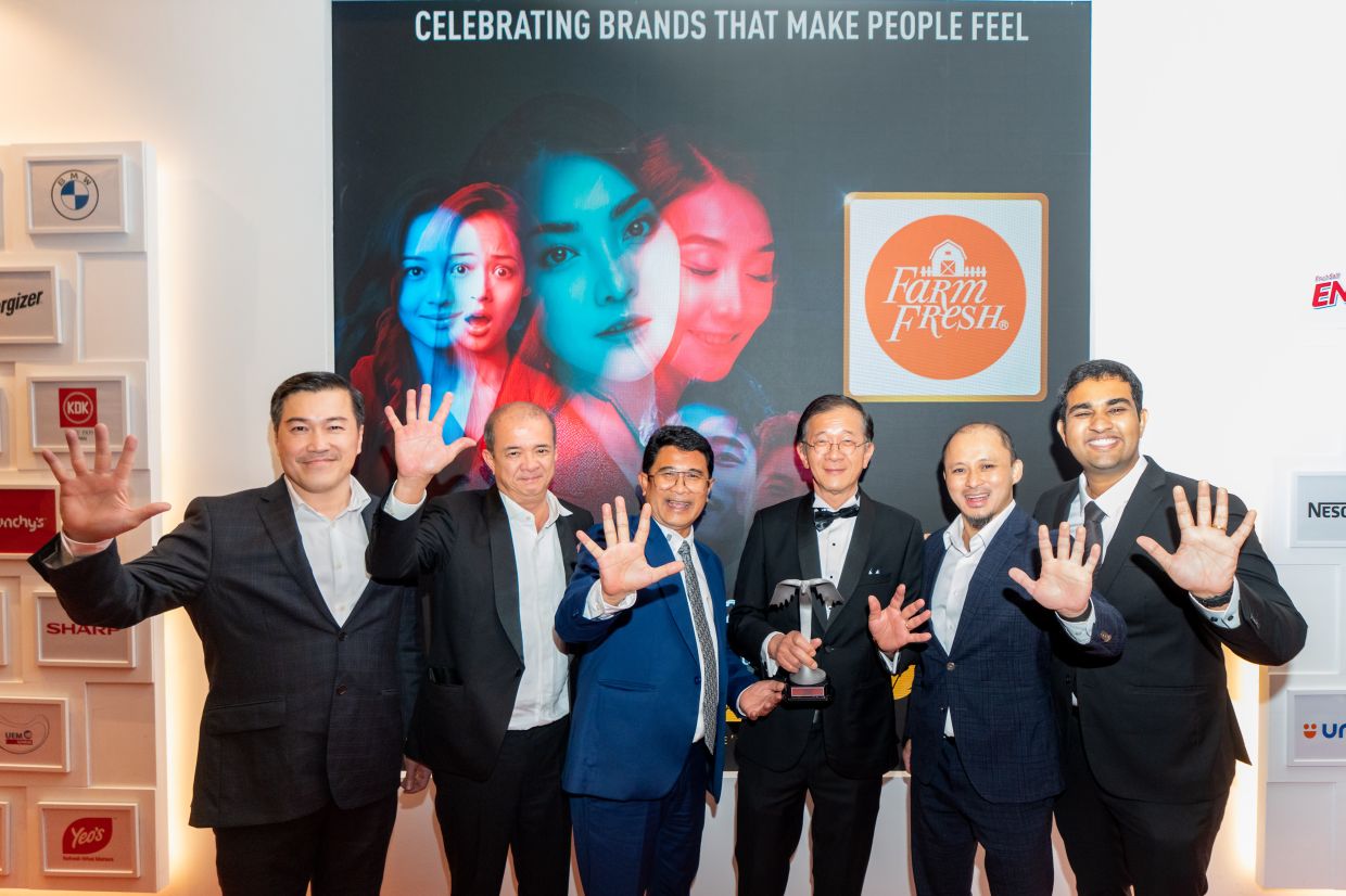 (From left) Farm Fresh Bhd sales director Ding Chai Thong, plant operations director Alex Loi, Azmi Zainal, Loi, group chief financial officer Mohd Khairul Mat Hassan and farm director Jacob Mathan capture a happy moment with their award at Putra Brand Awards 2025 gala night.