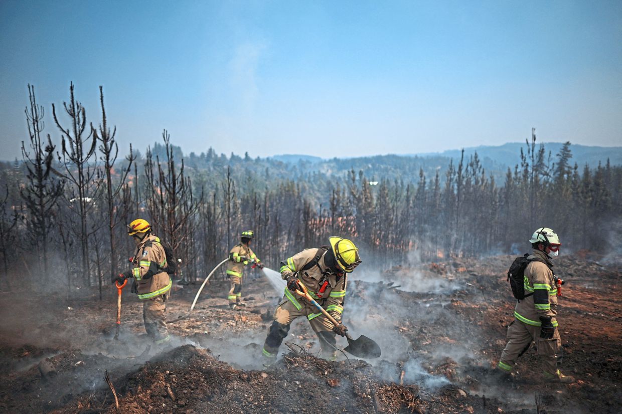 1. Firefighters battling a forest fire in Chile’s Biobio region, where multiple wildfires have forced emergency evacuations. — Reuters