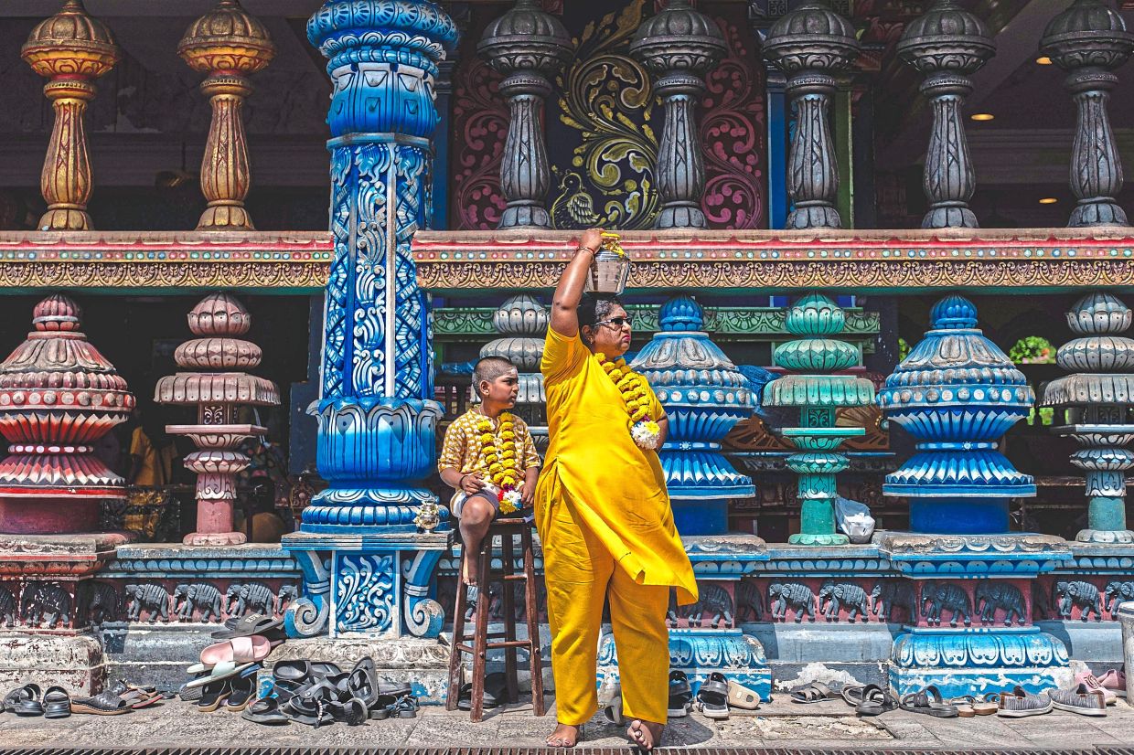 4. A woman carrying a milk pot on her head at Batu Caves, Selangor, as religious rituals and preparations begin ahead of Thaipusam. — Bernama