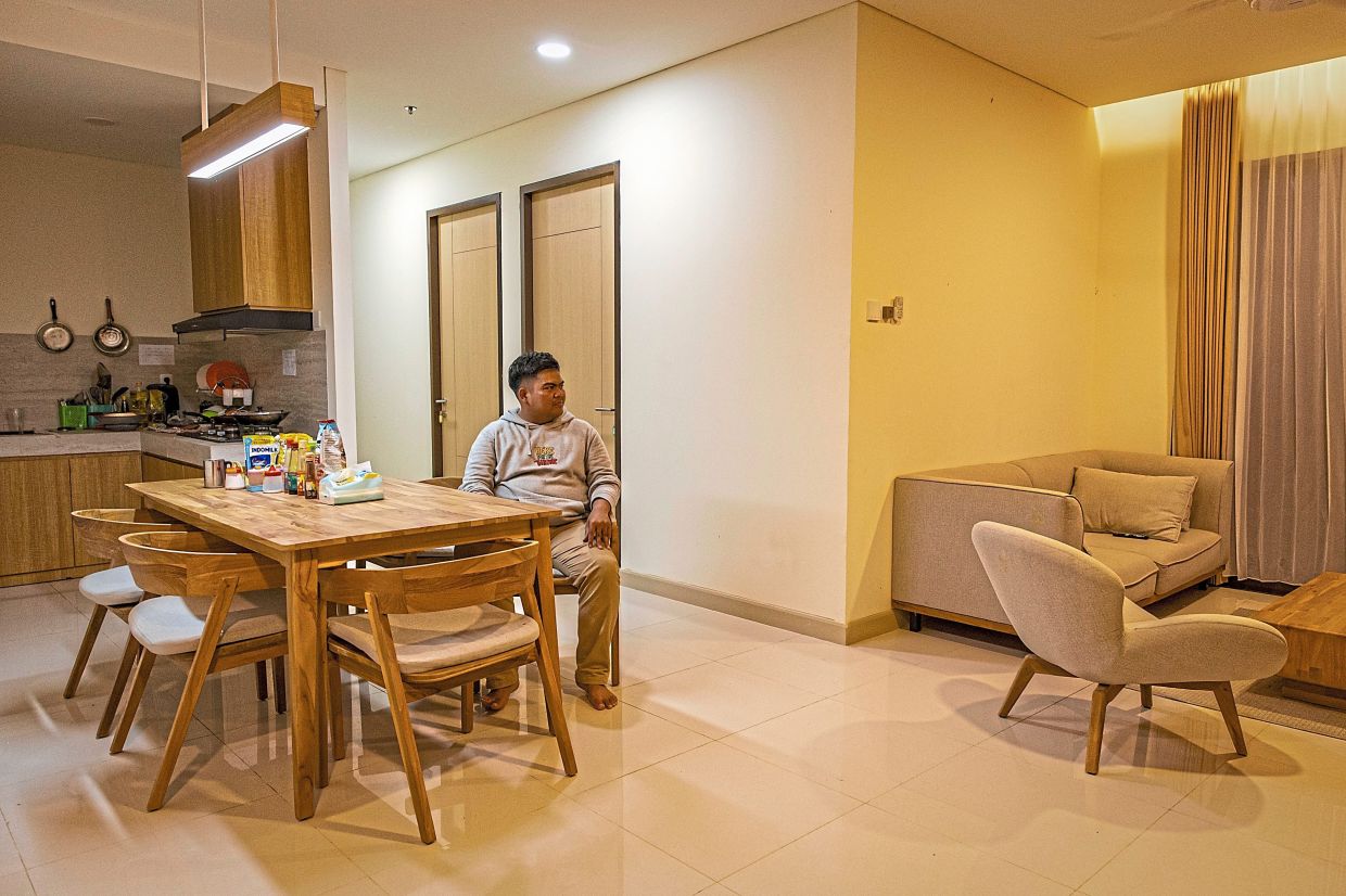 Fachri, a young data consultant in his 20s like many of the early residents, relaxing at his apartment in a residential complex for civil servants in Nusantara. — Ulet Ifansasti/The New York Times