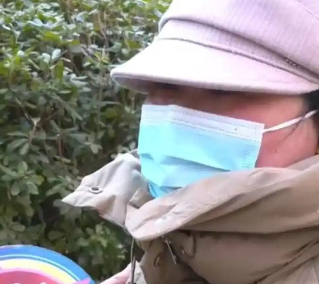 Li wearing a hat and mask as she continues being interviewed. -- Photo: Baidu/SCMP